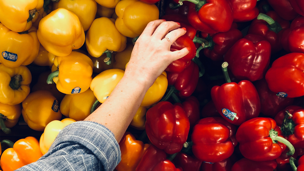 A woman picking out peppers