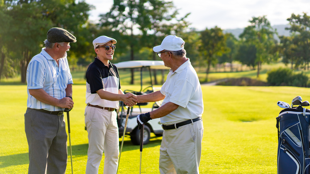 A group of men playing golf on a golf course