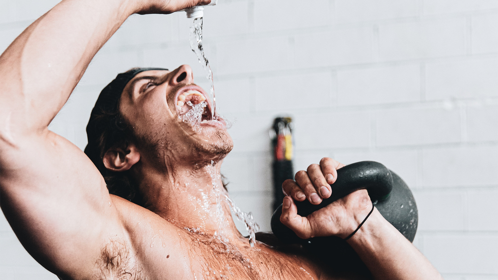 Man drinks water while working out